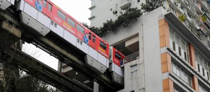 A miracle of Chinese architecture - a monorail through a residential building in Chongqing An electric train passes through a house